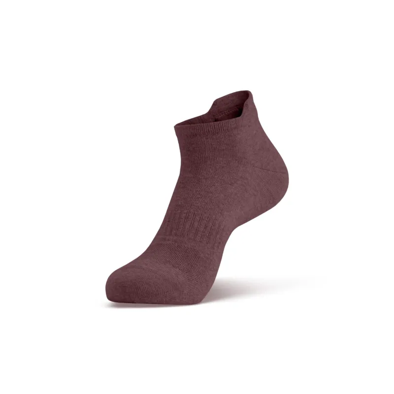 A single dark pink ankle sock shown on a foot model, angled to display the side profile and the top opening.