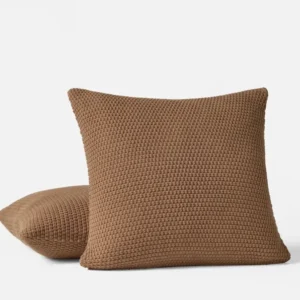 Coyuchi Avalon Knit decorative pillow in toffee, chunky woven texture, two pillows styled.