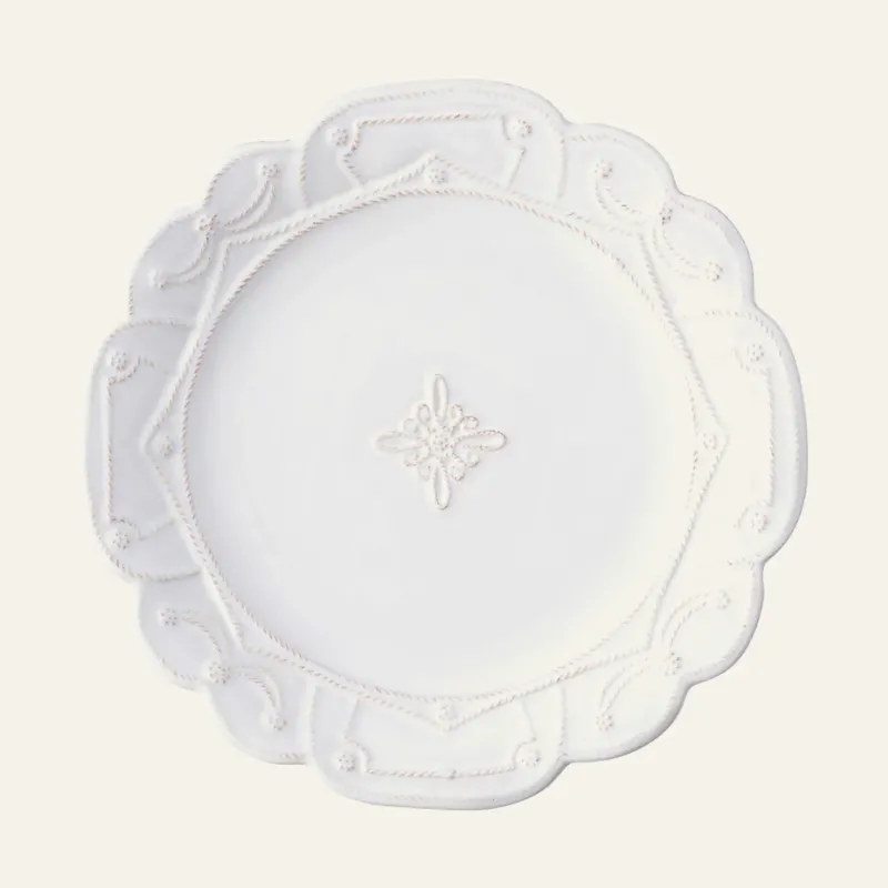 Juliska Jardins du Monde white stoneware dinner plate with scalloped edge and floral motif.