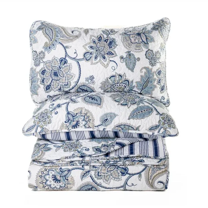 Floral patterned bedding set with a pillow on a white background