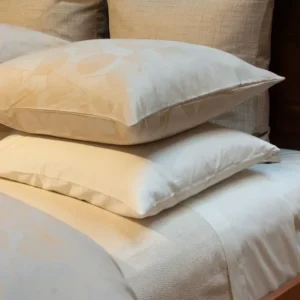 LETTO Ontano Jacquard king sham in champagne with floral pattern on styled bed.