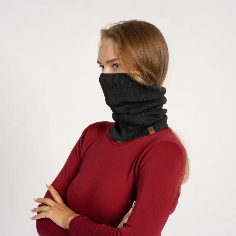 Woman in red shirt with dark gray knitted Merino wool gaiter pulled up over the face, side view.
