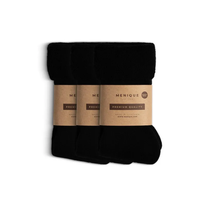 Three pairs of women’s black sherpa fleece socks, folded and wrapped in eco-friendly Menique brown paper bands labeled ‘Premium Quality – Merino Wool.