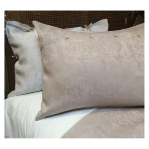 Leitner Mareil taupe damask pillow sham with decorative pins on white bedding.