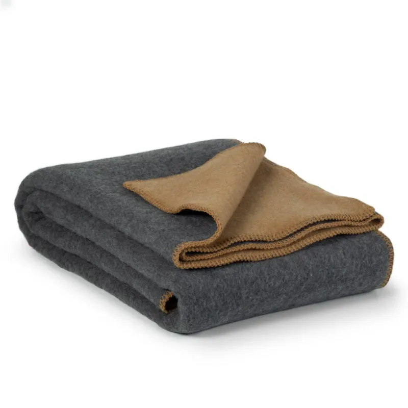 Folded Merino Wool Bedspread in Sun Dust, showing the wool-nylon blend texture