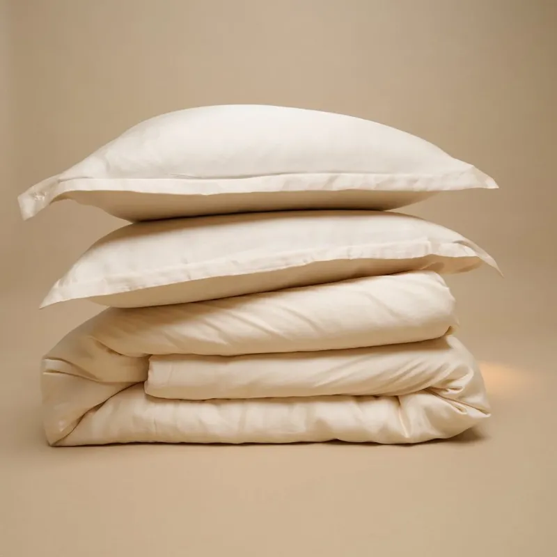 Tencel™ Sateen Duvet Cover and pillows in White Sand, folded
